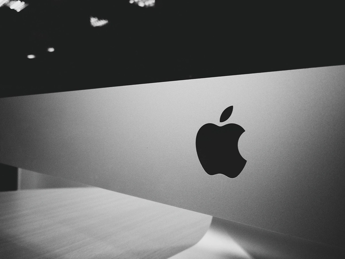 How to Trade Apple in 2025 -7 Smart Strategies For You To Master 1 Close-up of an Apple logo on a silver computer, emphasizing tech-related trading.