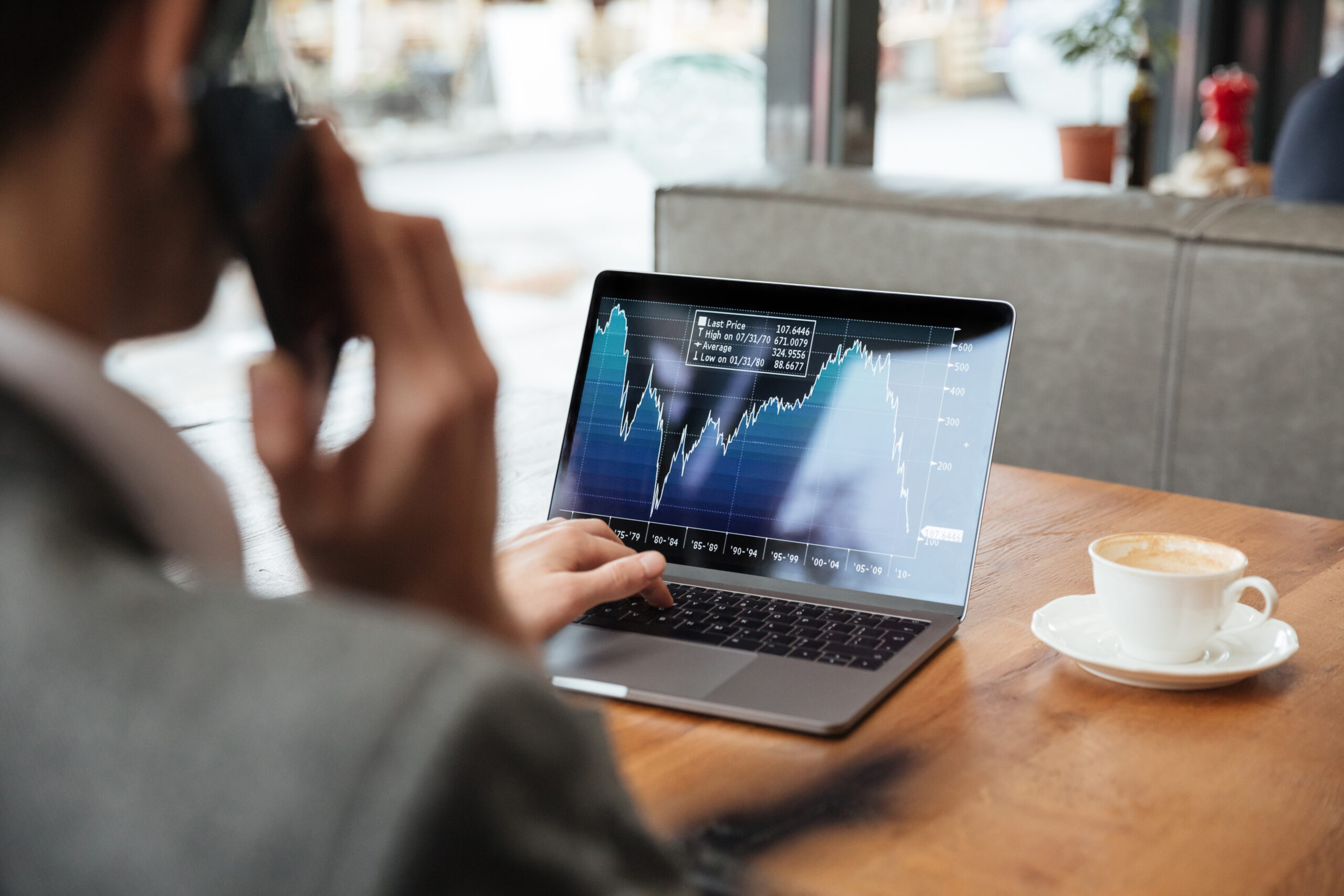 Man looking at a computer screen while researching the best online trading platform in South Africa