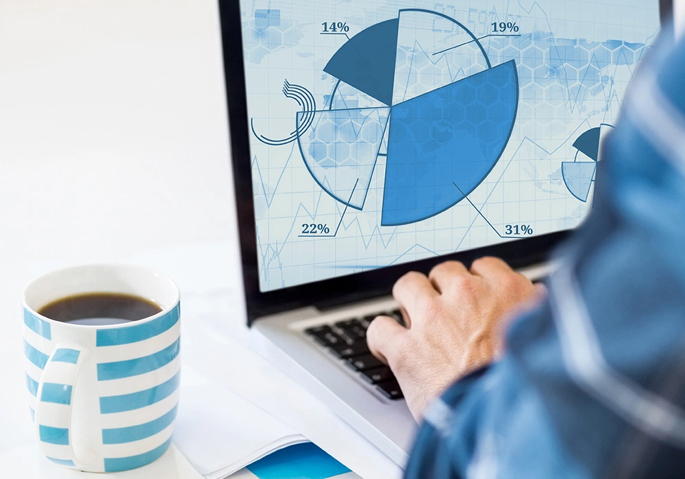 Building a Diversified Investment Portfolio to Balance Risk 2 Laptop showing portfolio pie chart with percentages beside a coffee mug