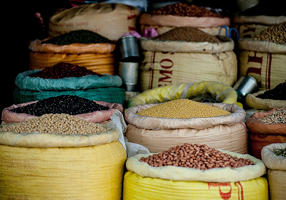 The Power of Commodities: Invest in the Backbone of the Global Economy 2 Sacks of grains and legumes displayed in a market with various commodities