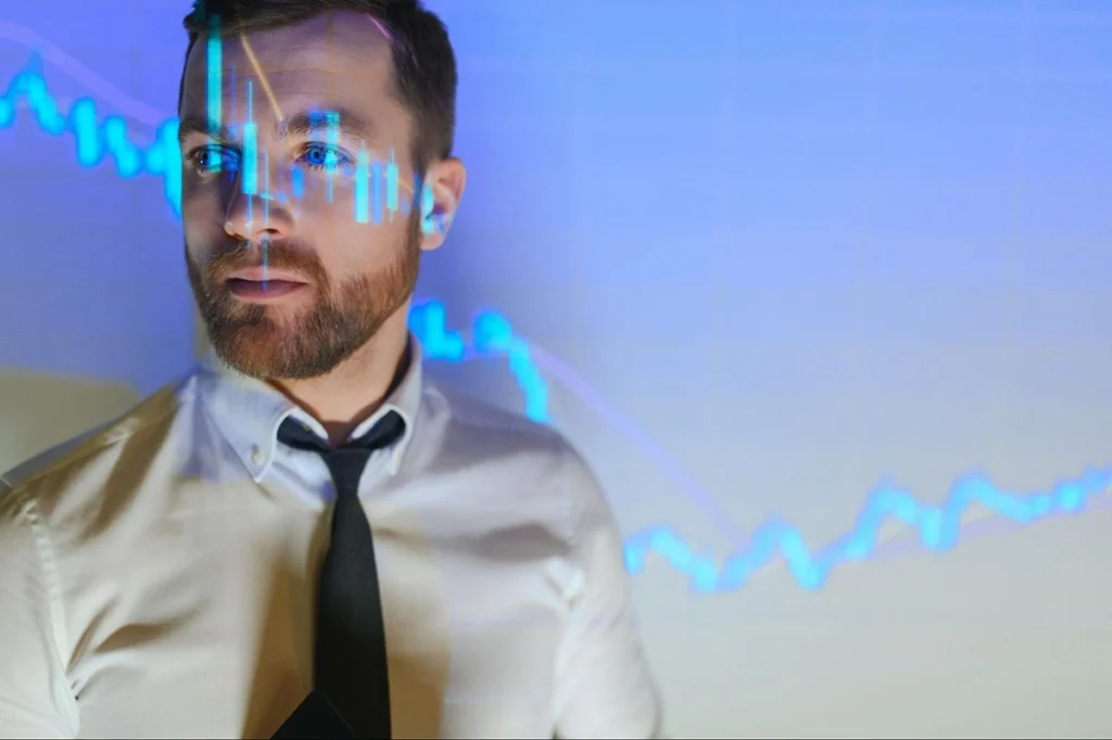 Using Volume Analysis to Boost Forex Profits 1 Trader analyzing market trends with stock chart overlay on face
